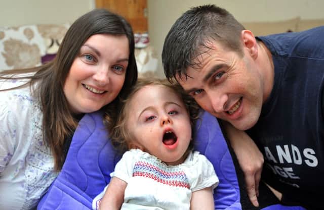 Lydia Rankin, two, with parents Ruth and Paul Rankin - Lydia has severe disabilities.