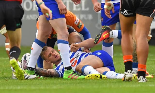 Wigan Warriors' Dominic Manfredi is injured by the tackle of Castleford Tigers' Rangi Chase

First Utility Super League match at The Mend-A-Hose Jungle, Castleford. Picture by Dave Howarth for BERNARD PLATT. Picture date: Friday August 12, 2016