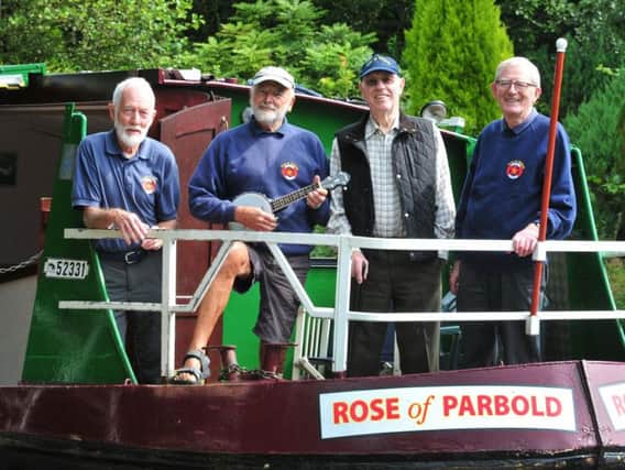 Rose of Parbold members, from left, Steve Hooley, Maurice Latham, Tom Emery and Mike Walker aboard their barge at  the Parbulele Ukelele Festival held in Parbold.