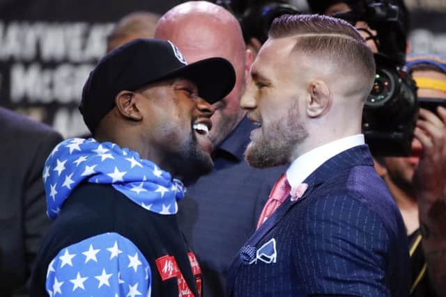 Boxer Floyd Mayweather Jr., left, and mixed martial arts fighter Conor McGregor exchange words during a news conference at Staples Center Tuesday, July 11, 2017, in Los Angeles. The two are scheduled to fight in a boxing match in Las Vegas