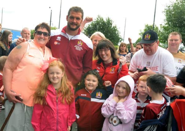 Captain Sean O'Loughlin meeting fans as the Warriors prepare to leave the DW Stadium to head to Wembley