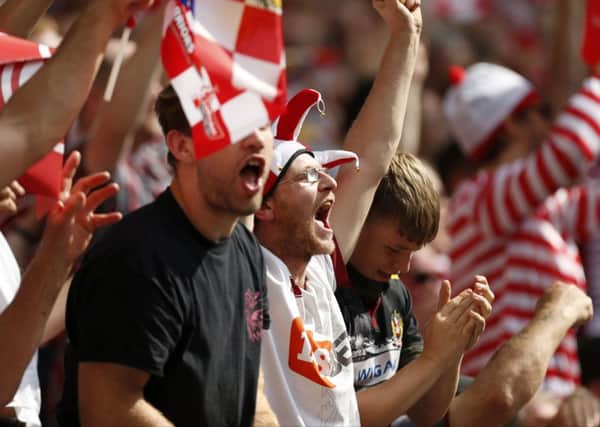Wigan Warriors' fans celebrate their sides first try during the Ladbrokes Challenge Cup Final