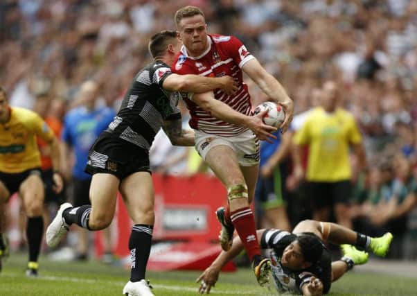 Hull FC's Jamie Shaul and Albert Kelly tackle Wigan Warriors' Joe Burgess during the Challenge  Cup Final