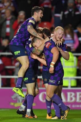 Wigan Warriors' George Williams is congratulated on scoring his team's 4th try
Betfred Super League match at the Totally Wicked Stadium, St Helens. Picture by DAVE HOWARTH for Bernard Platt. Picture date: Friday September 1, 2017