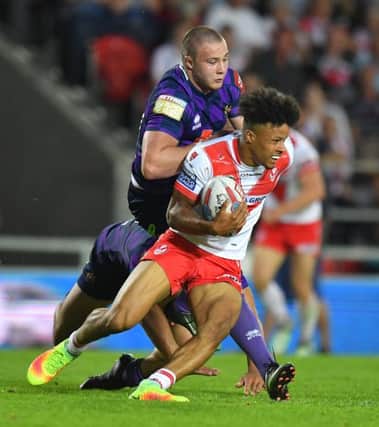 St Helens' Regan Grace is tackled by Wigan Warriors' Jack Wells Betfred Super League match at the Totally Wicked Stadium, St Helens. Picture by DAVE HOWARTH for Bernard Platt. Picture date: Thursday May 25, 2017