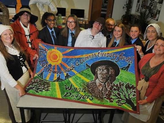 Hawkley Hall High School pupils present members of the Wigan Diggers Festival committee with their new flag for the event