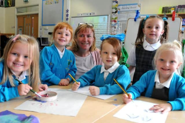 Molly with her teacher and some of her friends