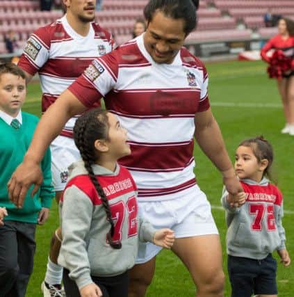 Taulima Tautai walks out with his two children