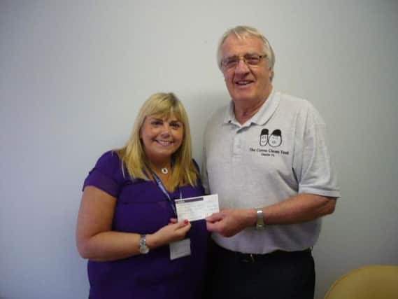 Sylvia Barnes of the Alzheimer's Society accepts a cheque from Eric Woods