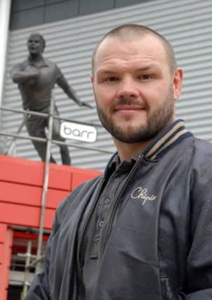 Keiron Cunningham outside his statue outside Saints' ground