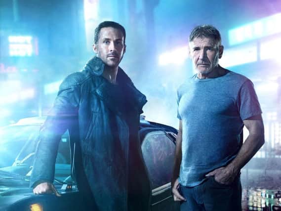 Ryan Gosling, as Agent K, and Harrison Ford, as Rick Deckard.