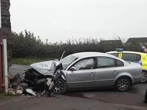 Police were alerted after a car struck a farm building in Latham Lane
