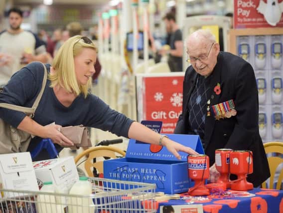 Poppy seller Ron Jones, who is 100 years old, at his selling station inside Tesco supermarket