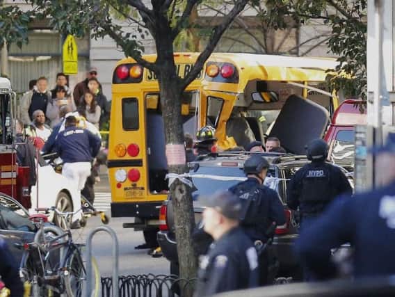 Authorities respond near a damaged school bus in New York. A motorist drove onto a busy bicycle path near the World Trade Center memorial and struck several people on Tuesday police and witnesses said
