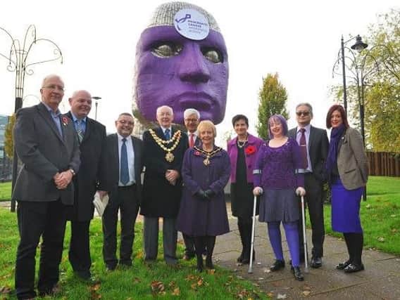 The Mayor of Wigan, Coun Bill Clarke, councillors, council staff and WWL staff at the unveiling of the mask