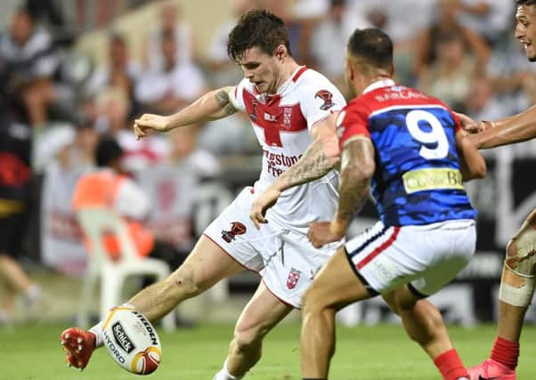 John Bateman kicks the ball on against France