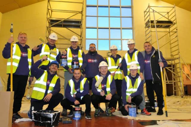 Wigan Warriors players and members of the Wigan Warriors Community Foundation spend the evening painting the church hall at St Barnabas, Marsh Green, Wigan