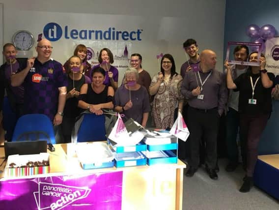 Kieron Smith (second right) with his colleagues at Learndirect, wearing purple for Pancreatic Awareness Day