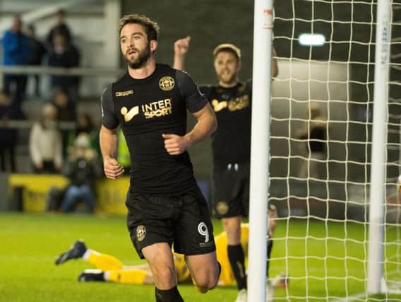 Will Grigg celebrates scoring his goal at AFC Fylde