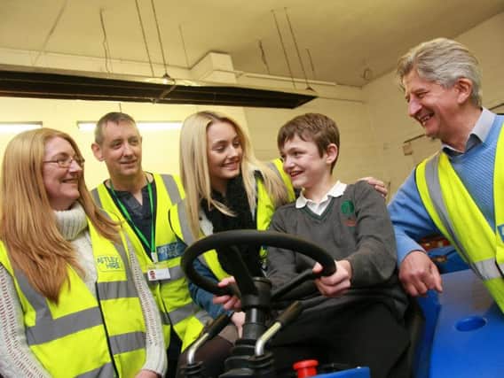 Grace and Reece Lynch, centre, with mum Carole Lynch, Paul Carroll, of Wigan And Leigh Young Carers, and Astley Hire MD Stephen Dorricott.