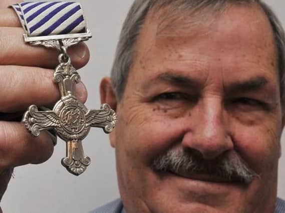 John Higham with his dads war medal