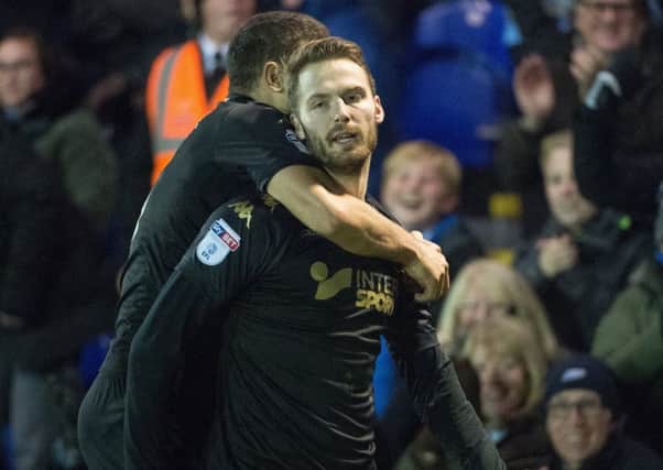 Nick Powell is congratulated by Sam Morsy