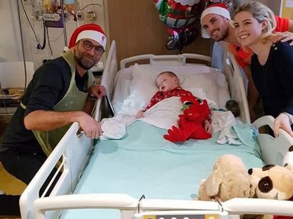 Liverpool manager Jurgen Klopp at Harrys bedside last year and, inset, healthy and back home with his delighted mum and dad