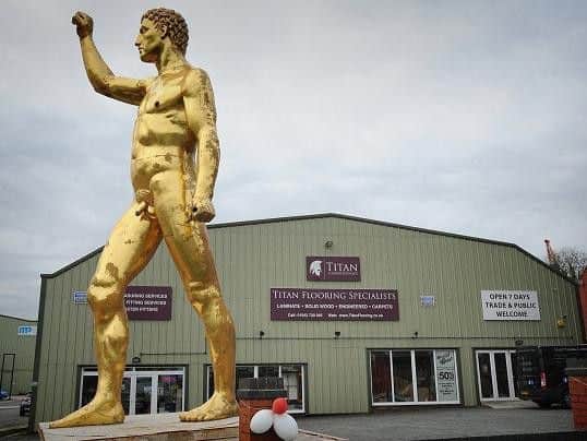 A dazzling gold statue brightening the car park of Titan Flooring in Landgate