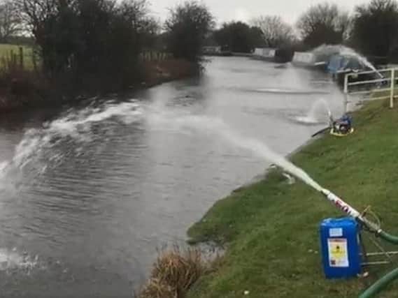 Environment Agency officials treat the water in a frantic bid to save the fish and other wildlife