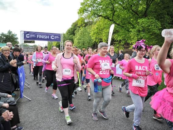 Runners cross the start line of last year's Race For Life at Haigh Woodland Park