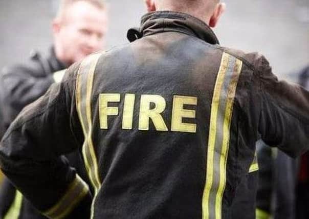 Firefighters were alerted after two cars burst into flames near a busy junction in Wigan
