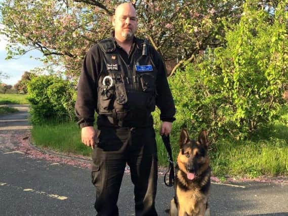 Dog handler Dougie Brown at Inquest Canine Detection & Security Limited in Leigh