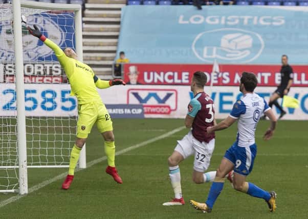 Will Grigg scores the opening goal for Latics against West Ham