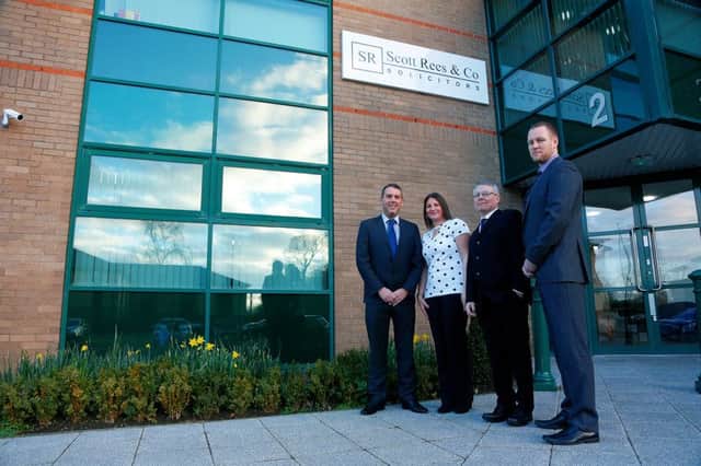 Ian Wadsworth Adele Platt Gary Milligan and Stephen Hussey stand outside the new building at 2 The Parks Haydock with the firms Scott Rees Solicitors sign in the background