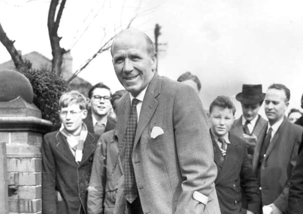 United manager Matt Busby  still on crutches, arriving home in Manchester from Munich