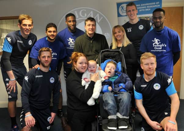 WIGAN  06-02-18
Wigan Athletic players show their support and promote the Joseph's Goal charity walk from Wigan to Fleetwood in April, players pictured with Joe Kendrick, eight, the inspiration for Joseph's Goal charity, with proud parents Emma Kendrick, holding son Tom, Paul Kendrick, back centre, and Joe's personal assistant Lisa Shrives, fourth from right,