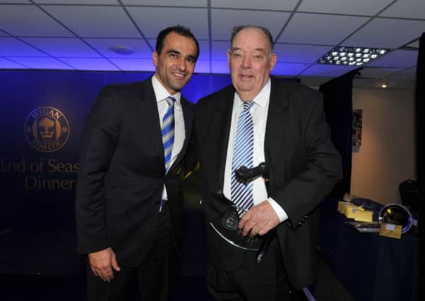 Brian Sabin is presented with the Latics 'Fan of the Year' award by Roberto Martinez