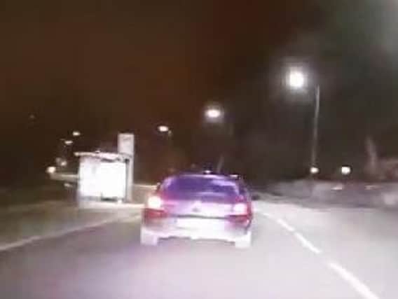 A still from the dash-cam footage of the police pursuit, after an officer suffered broken fingers when his patrol car was rammed