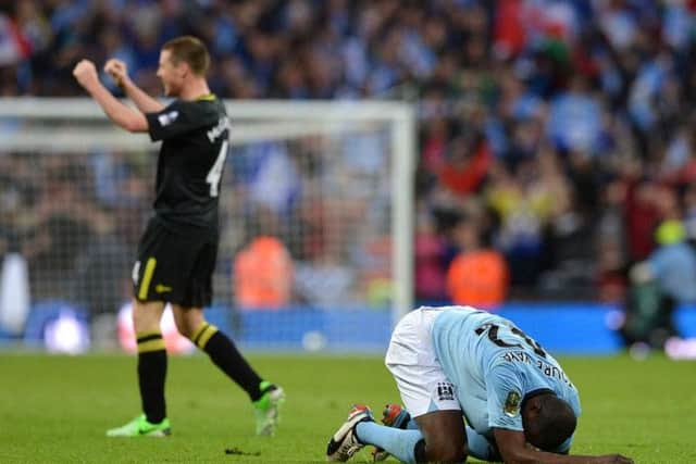 Wigan's James McCarthy celebrates the final whistle at Wembley in 2013 as City's Yaya Toure slumps to the ground