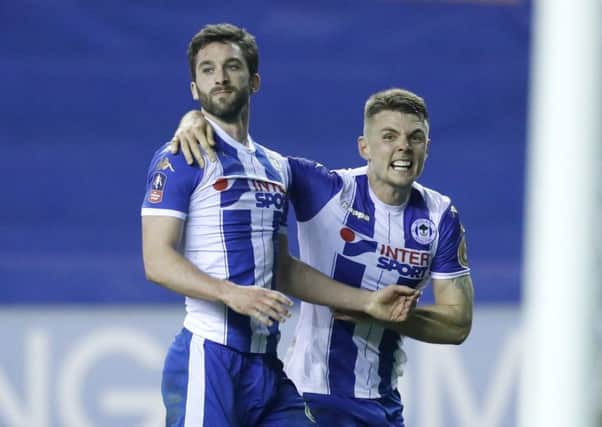 Will Grigg and Max Power celebrate the winning goal