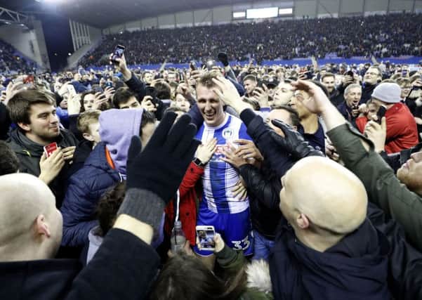 Wigan Athletic's Dan Burn is mobbed by fans after the Emirates FA Cup, Fifth Round match at the DW Stadium