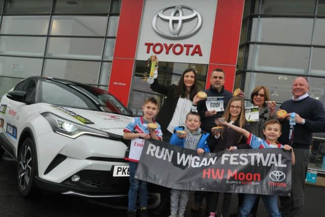 Jack Johnson (front left) at the official handover of the lead car at HW Moon Toyota with back row, mum Alex Johnson, uncle Matt Johnson, Dorothy Moon and Steven Mather from HW Moon, and front row his cousins Ellis Johnson and Niamh Johnson, and his brother James