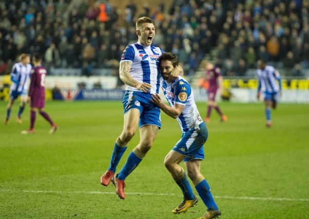 Will Grigg and Max Power celebrate the winning goal against Manchester City