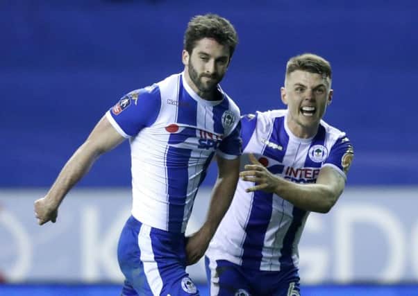 Max Power congratualtes Will Grigg on his goal on Monday