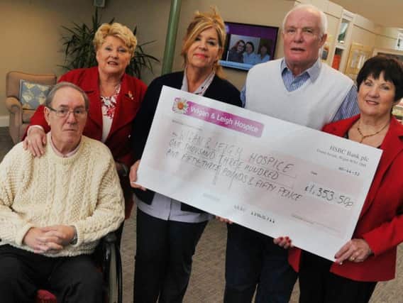 Neil Aspinall's family present the cheque to Wigan and Leigh Hospice