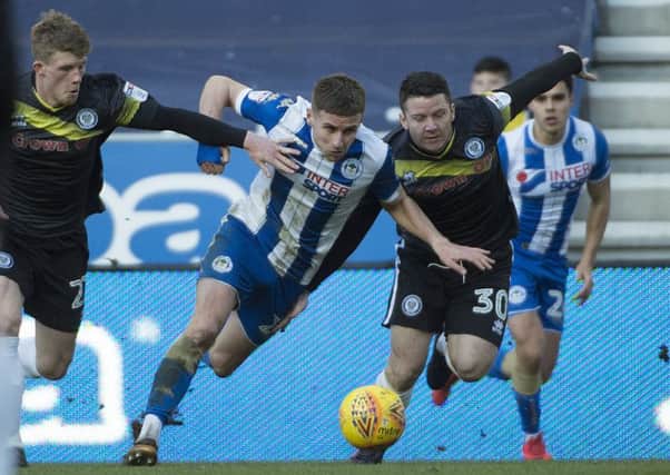 Ryan Colclough gets stuck in against Rochdale