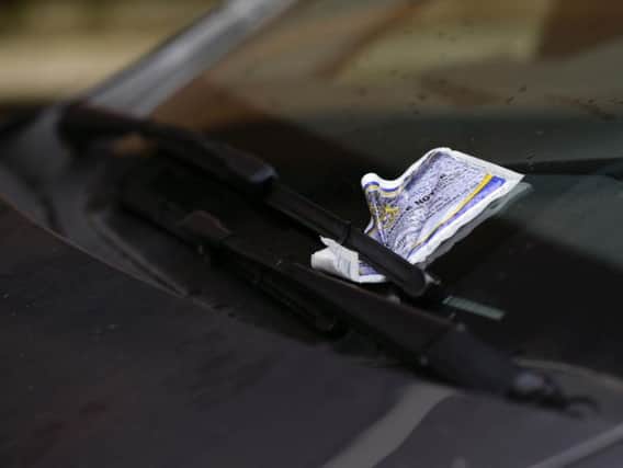 A parking ticket placed on the windscreen of a car