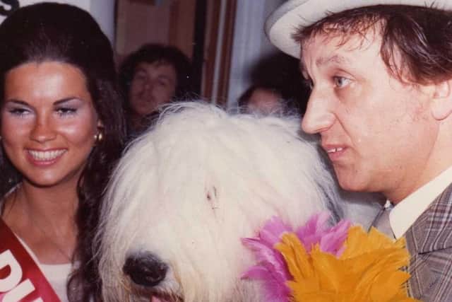 Well known Wigan beauty queen Wendy George joins Ken Dodd at the opening of a Wigan wallpaper shop. And the Dulux dog was another star attraction