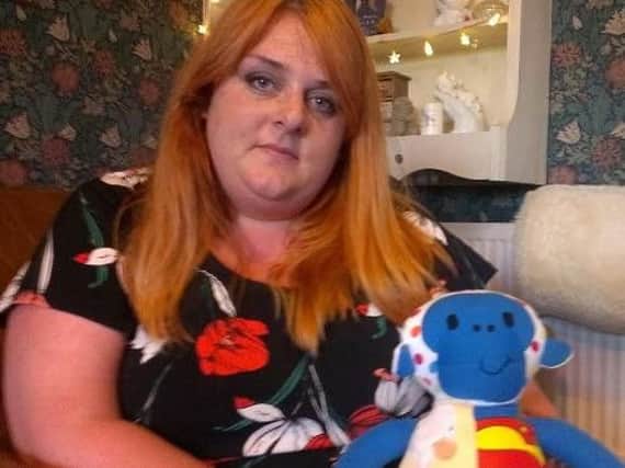Laura Monks with a teddy made out of babygrows she bought for her son Rueben