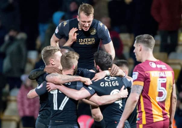 Match-winner Michael Jacobs is mobbed at Bradford